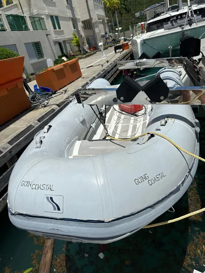 Goin' Coastal Yacht Photos Pics Inflatable dinghy docked near a 2018 Fountaine Pajot Helia 44 Evolution catamaran.