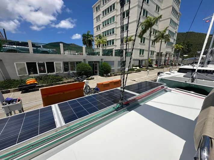Goin' Coastal Yacht Photos Pics 2018 Fountaine Pajot Helia 44 Evolution catamaran with solar panels docked near modern buildings.