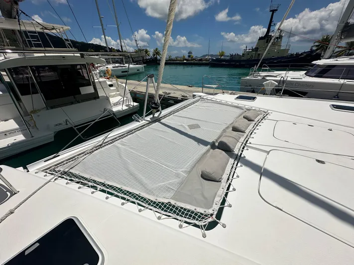 Goin' Coastal Yacht Photos Pics 2018 Fountaine Pajot Helia 44 Evolution catamaran with sunbathing net and cushions, docked at marina.