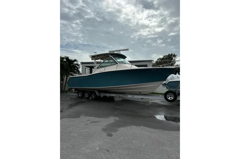 Rising Sun Yacht Photos Pics 2018 Grady-White Express 330 boat on trailer, parked outdoors under cloudy sky.