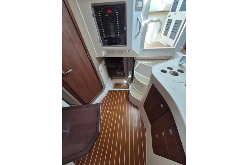 Rising Sun Yacht Photos Pics 2018 Grady-White Express 330 cabin interior with wood flooring and control panel.