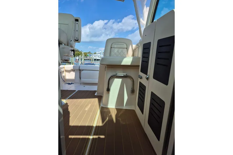 Rising Sun Yacht Photos Pics 2018 Grady-White Express 330 boat interior with seating and storage, under a clear blue sky.