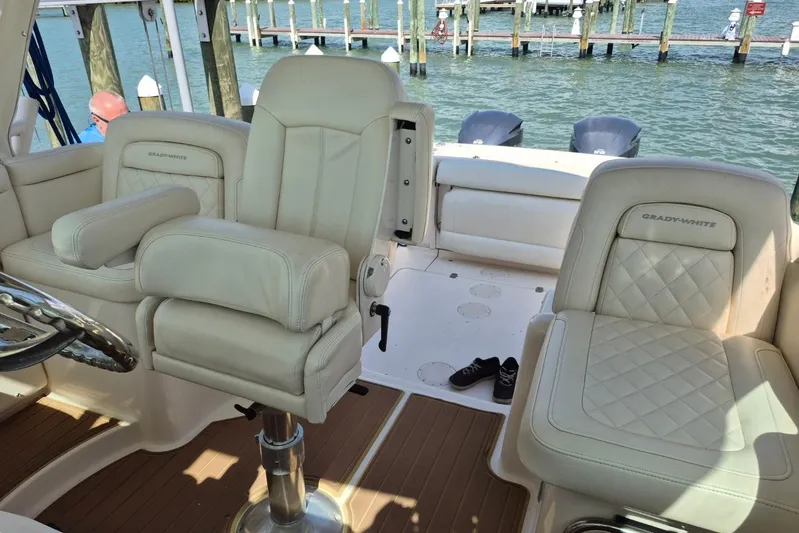 Rising Sun Yacht Photos Pics 2018 Grady-White Express 330 boat interior with plush seating and scenic marina view.