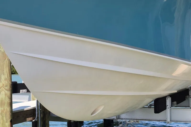 Rising Sun Yacht Photos Pics 2018 Grady-White Express 330 boat hull in dry dock, showcasing sleek design.