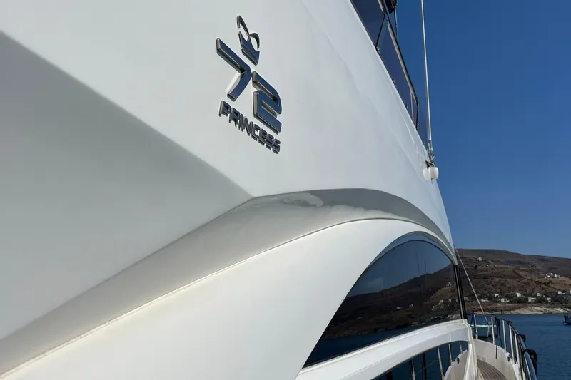  Yacht Photos Pics 2012 Princess 72 Motor Yacht, sleek design, cruising on a clear blue sea.
