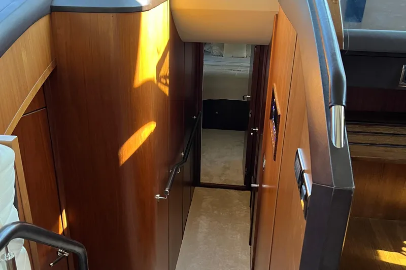  Yacht Photos Pics Interior view of 2012 Princess 72 Motor Yacht, featuring wooden paneling and staircase.