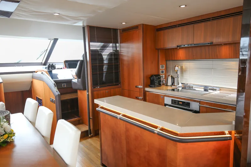  Yacht Photos Pics Luxurious interior of 2012 Princess 72 Motor Yacht with modern kitchen and dining area.