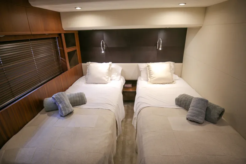  Yacht Photos Pics Luxurious twin bedroom in 2012 Princess 72 Motor Yacht with elegant wood paneling.