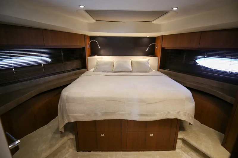  Yacht Photos Pics Luxurious bedroom interior of 2012 Princess 72 Motor Yacht with elegant wood finishes.