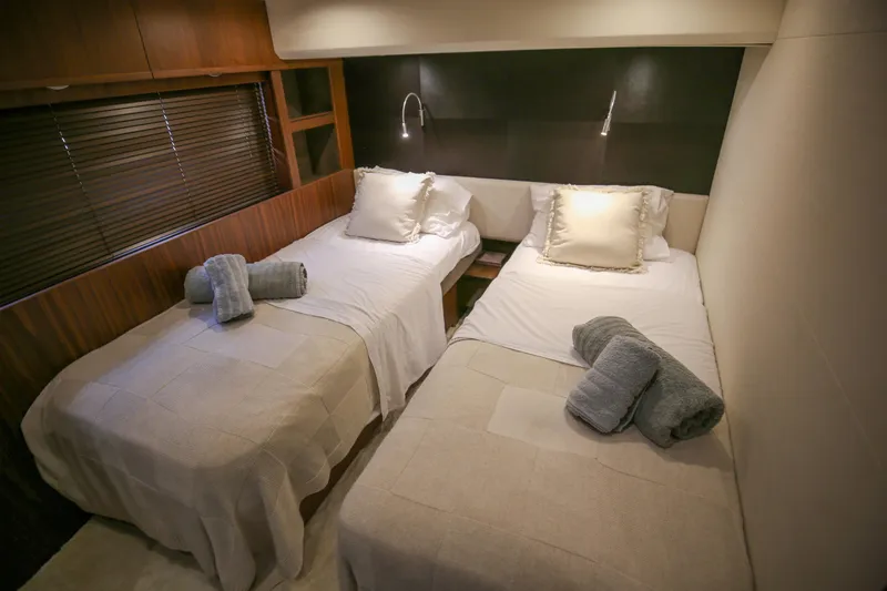  Yacht Photos Pics Luxurious twin bedroom in 2012 Princess 72 Motor Yacht, featuring elegant decor and cozy bedding.