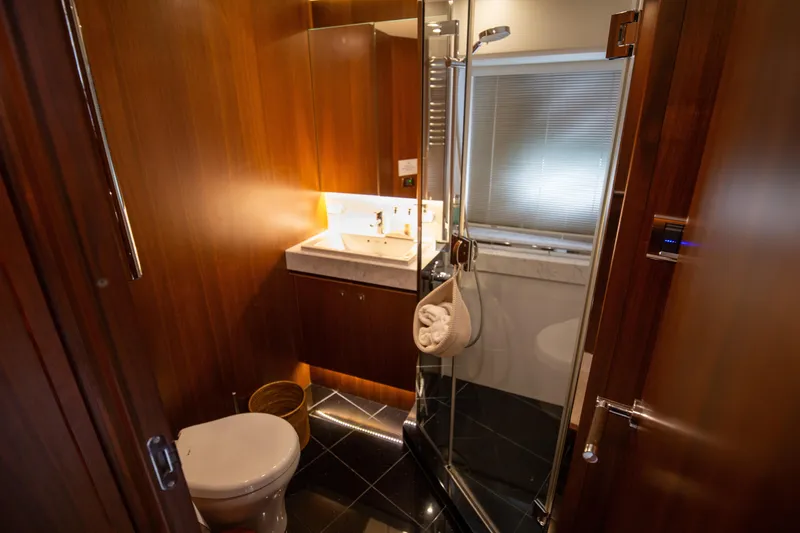  Yacht Photos Pics Luxurious bathroom in 2012 Princess 72 Motor Yacht with wood paneling and modern fixtures.