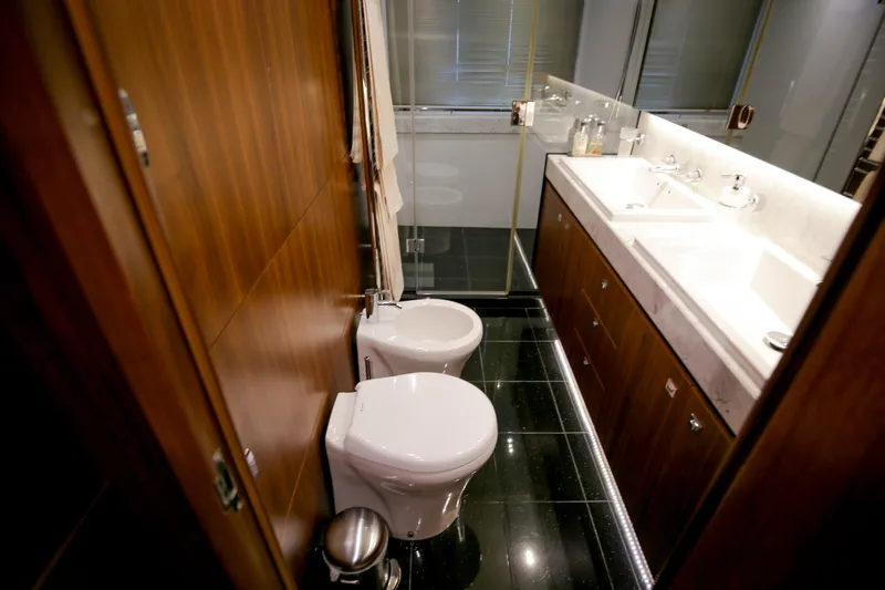  Yacht Photos Pics Luxurious bathroom in 2012 Princess 72 Motor Yacht with modern fixtures and elegant wood paneling.