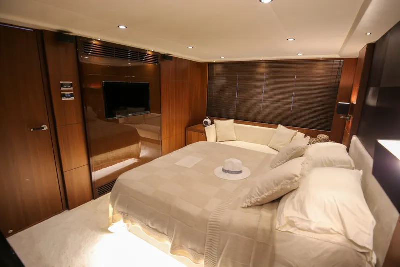  Yacht Photos Pics Luxurious bedroom interior of 2012 Princess 72 Motor Yacht with elegant wood paneling and cozy bedding.