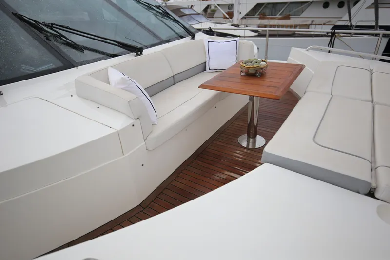 Yacht Photos Pics Luxurious seating area on 2012 Princess 72 Motor Yacht with wooden table and cushions.
