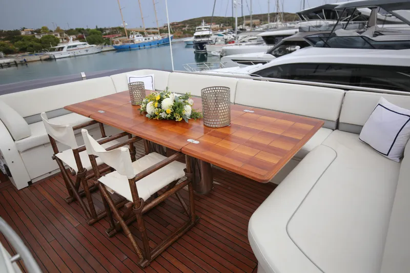  Yacht Photos Pics Luxurious 2012 Princess 72 Motor Yacht deck with elegant dining area and scenic marina view.