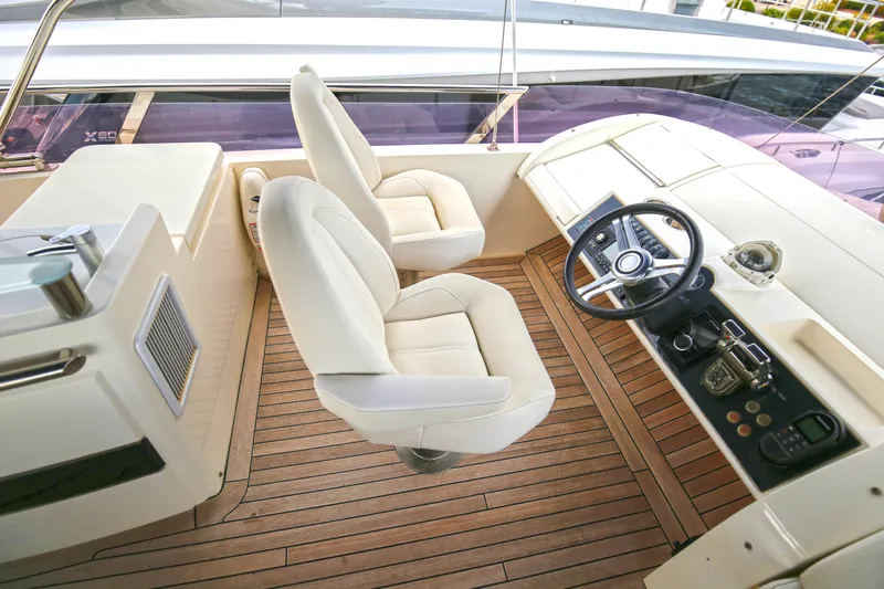  Yacht Photos Pics Luxurious helm of 2012 Princess 72 Motor Yacht with plush seating and modern controls.