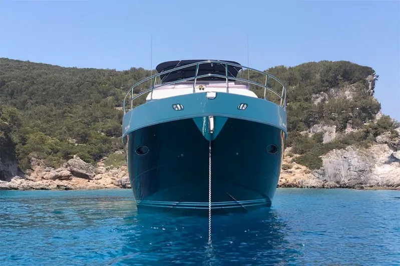  Yacht Photos Pics Front view of a 2012 Princess 72 Motor Yacht anchored in clear blue waters.