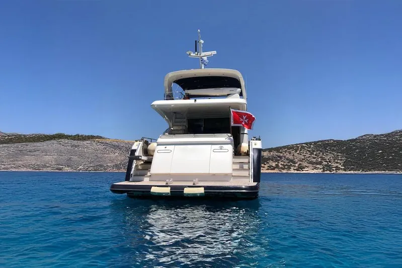  Yacht Photos Pics 2012 Princess 72 Motor Yacht on clear blue water, scenic coastal backdrop.