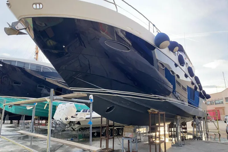  Yacht Photos Pics 2012 Princess 72 Motor Yacht in dry dock, showcasing sleek design and blue hull.