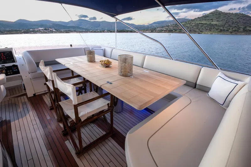  Yacht Photos Pics Luxurious 2012 Princess 72 Motor Yacht deck with elegant dining area and scenic ocean view.