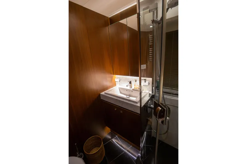  Yacht Photos Pics Luxurious bathroom on 2012 Princess 72 Motor Yacht with modern fixtures and elegant wood paneling.