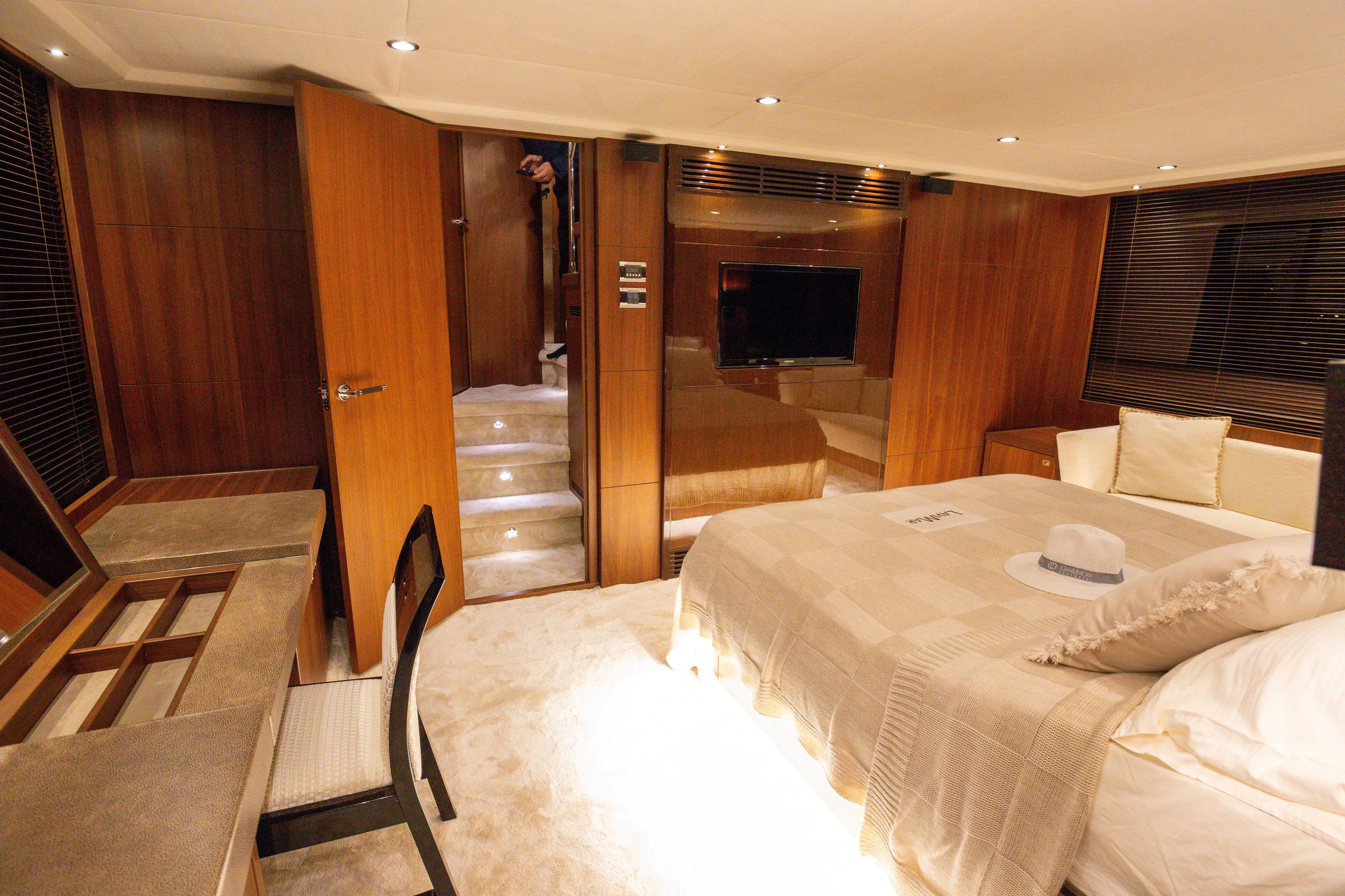  Yacht Photos Pics Luxurious interior of 2012 Princess 72 Motor Yacht with elegant wood finishes and cozy furnishings.