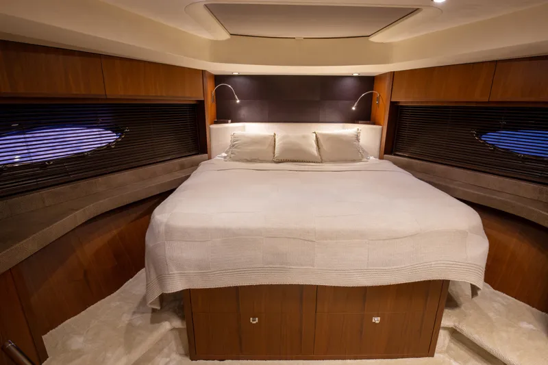  Yacht Photos Pics Luxurious bedroom interior of 2012 Princess 72 Motor Yacht with elegant wood finishes.