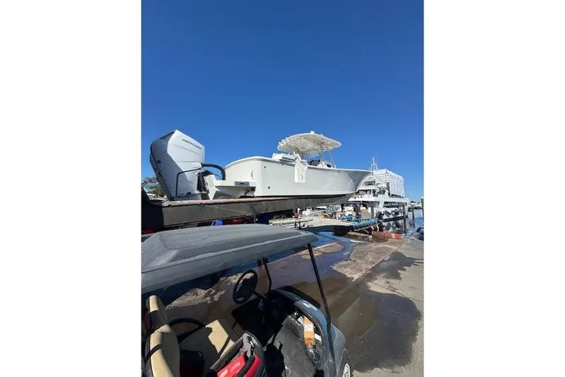  Yacht Photos Pics 2018 Regulator 34 Center Console boat on trailer at marina under clear blue sky.