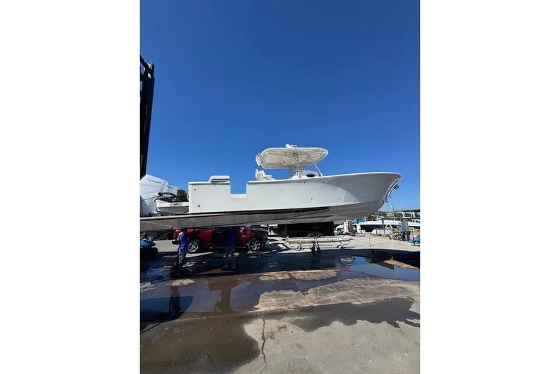  Yacht Photos Pics 2018 Regulator 34 Center Console boat on a lift under clear blue sky.