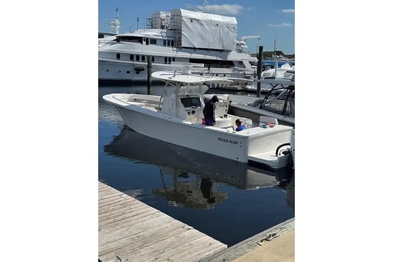  Yacht Photos Pics 2018 Regulator 34 Center Console boat docked at marina with yachts in background.