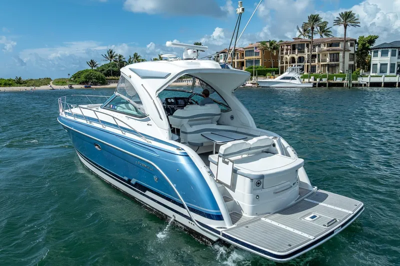  Yacht Photos Pics 2022 Formula 40 Performance Cruiser on water near luxury waterfront homes.