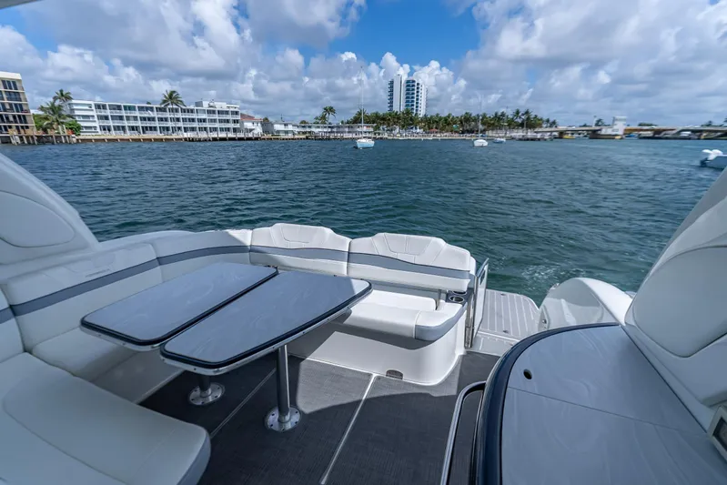  Yacht Photos Pics 2022 Formula 40 Performance Cruiser, luxurious deck view, waterfront cityscape, blue sky, and clouds.