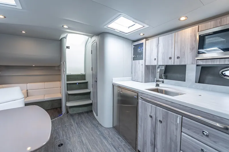  Yacht Photos Pics Luxurious interior of 2022 Formula 40 Performance Cruiser with modern kitchen and seating area.