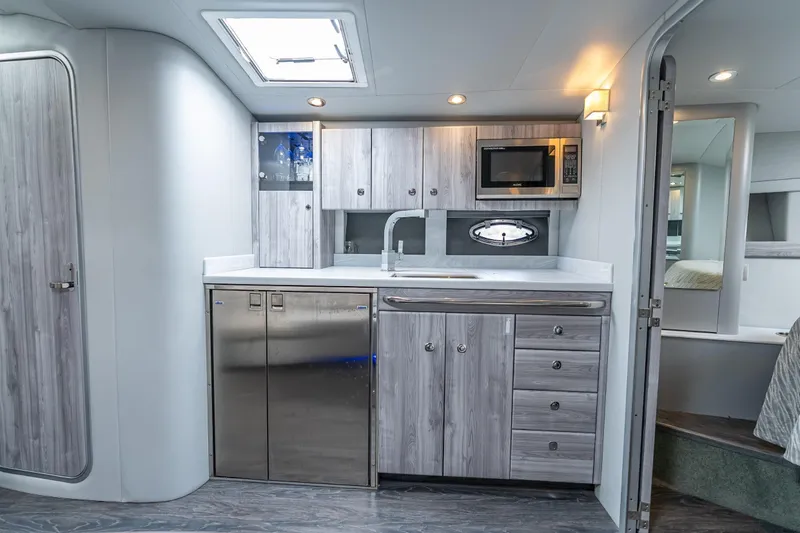  Yacht Photos Pics Modern kitchen in 2022 Formula 40 Performance Cruiser with sleek cabinetry and stainless steel appliances.