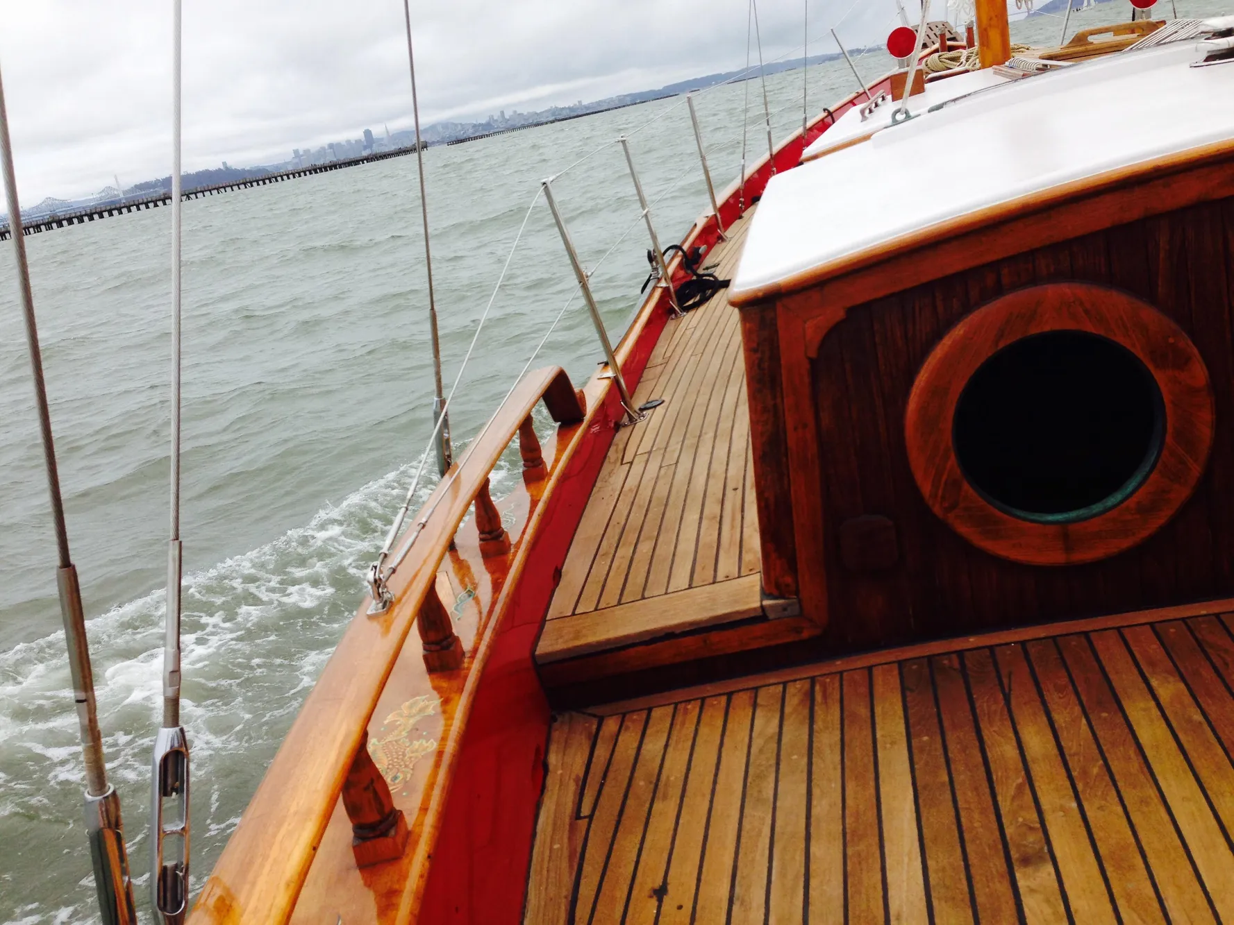 Wooden deck of a 1971 Formosa 41 sailboat on the water.
