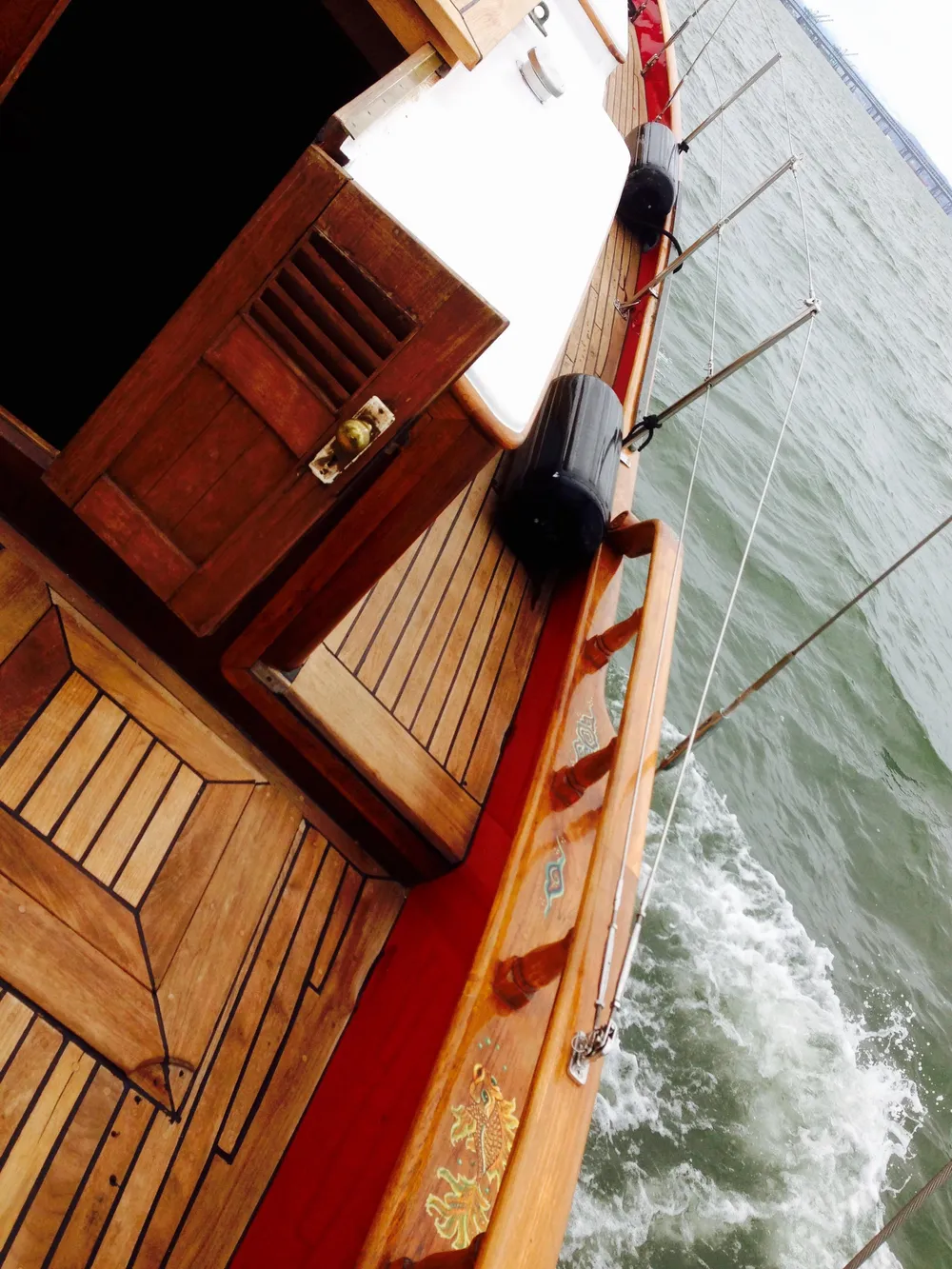 1971 Formosa 41 sailboat with wooden deck, sailing on open water.