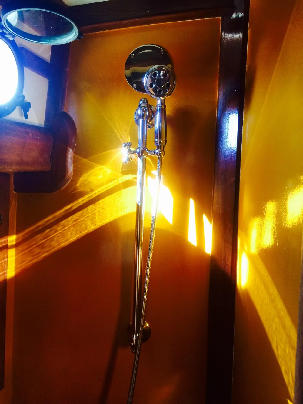Shower area in a 1971 Formosa 41 yacht, illuminated by sunlight.