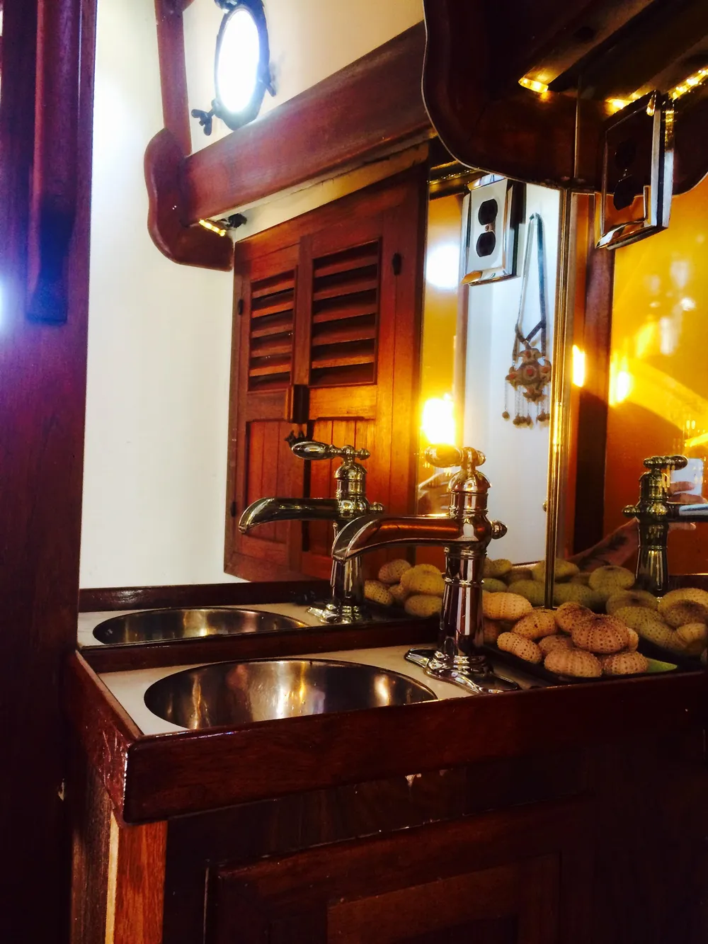 Vintage 1971 Formosa 41 yacht interior with wooden cabinetry and dual sinks.