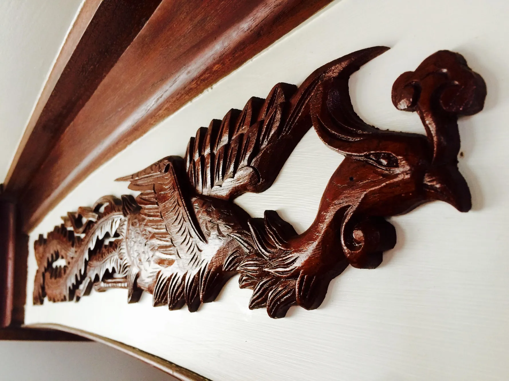 Intricate wooden carving on 1971 Formosa 41, featuring a detailed dragon design.