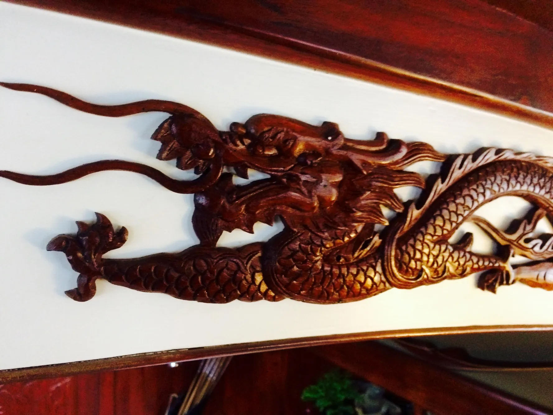 Intricate dragon carving on 1971 Formosa 41 yacht interior.