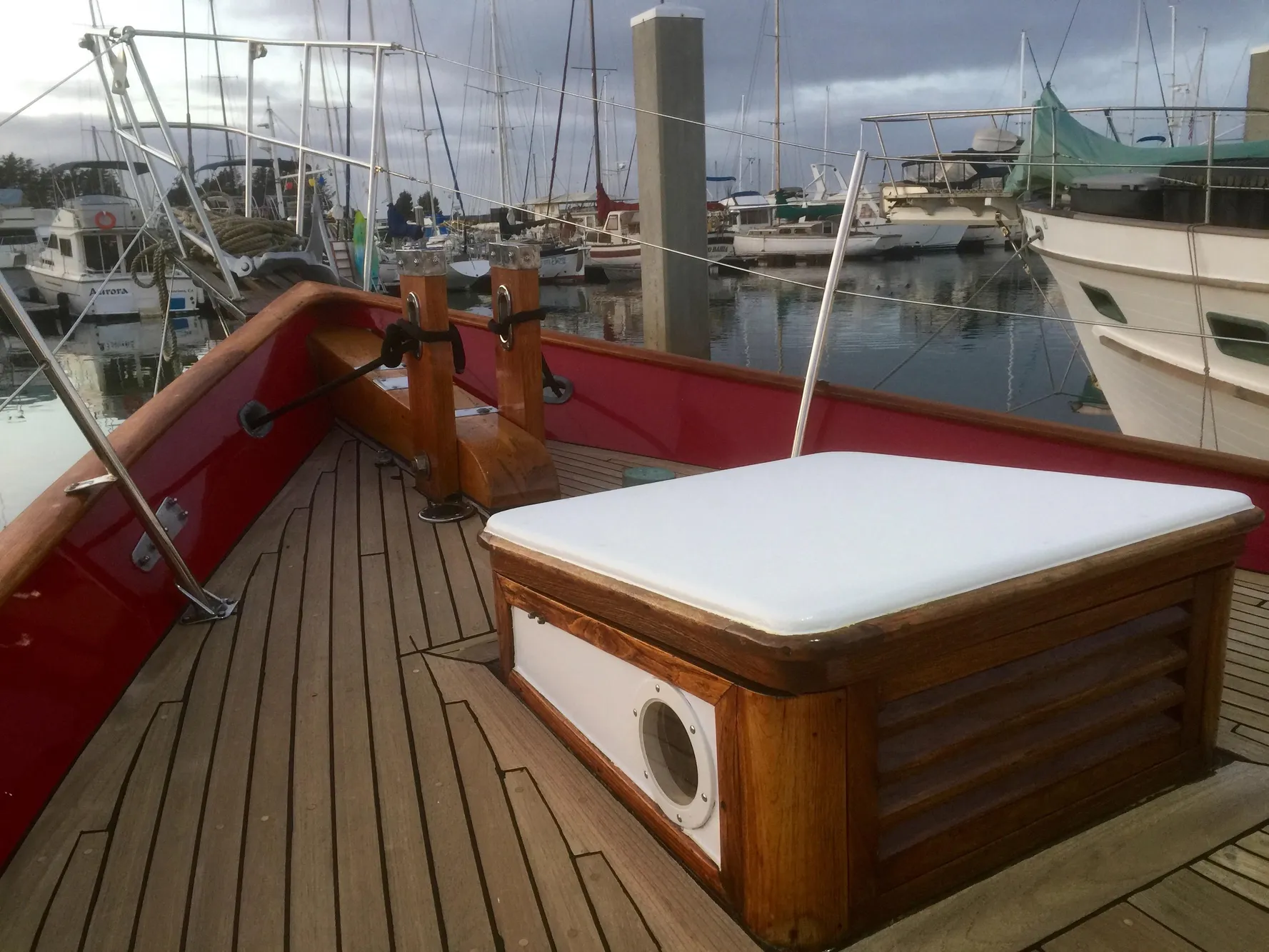 1971 Formosa 41 sailboat deck with wooden details, docked in a marina.