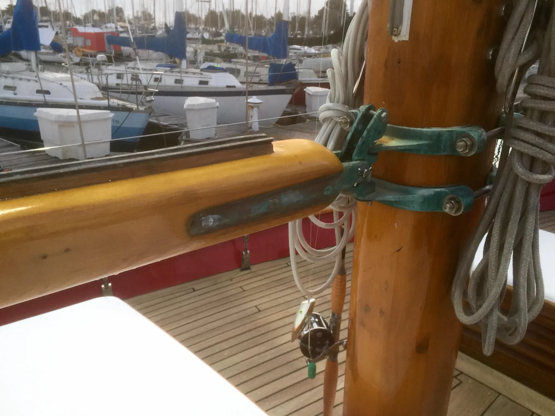 Wooden mast and rigging on a 1971 Formosa 41 sailboat, docked in a marina.