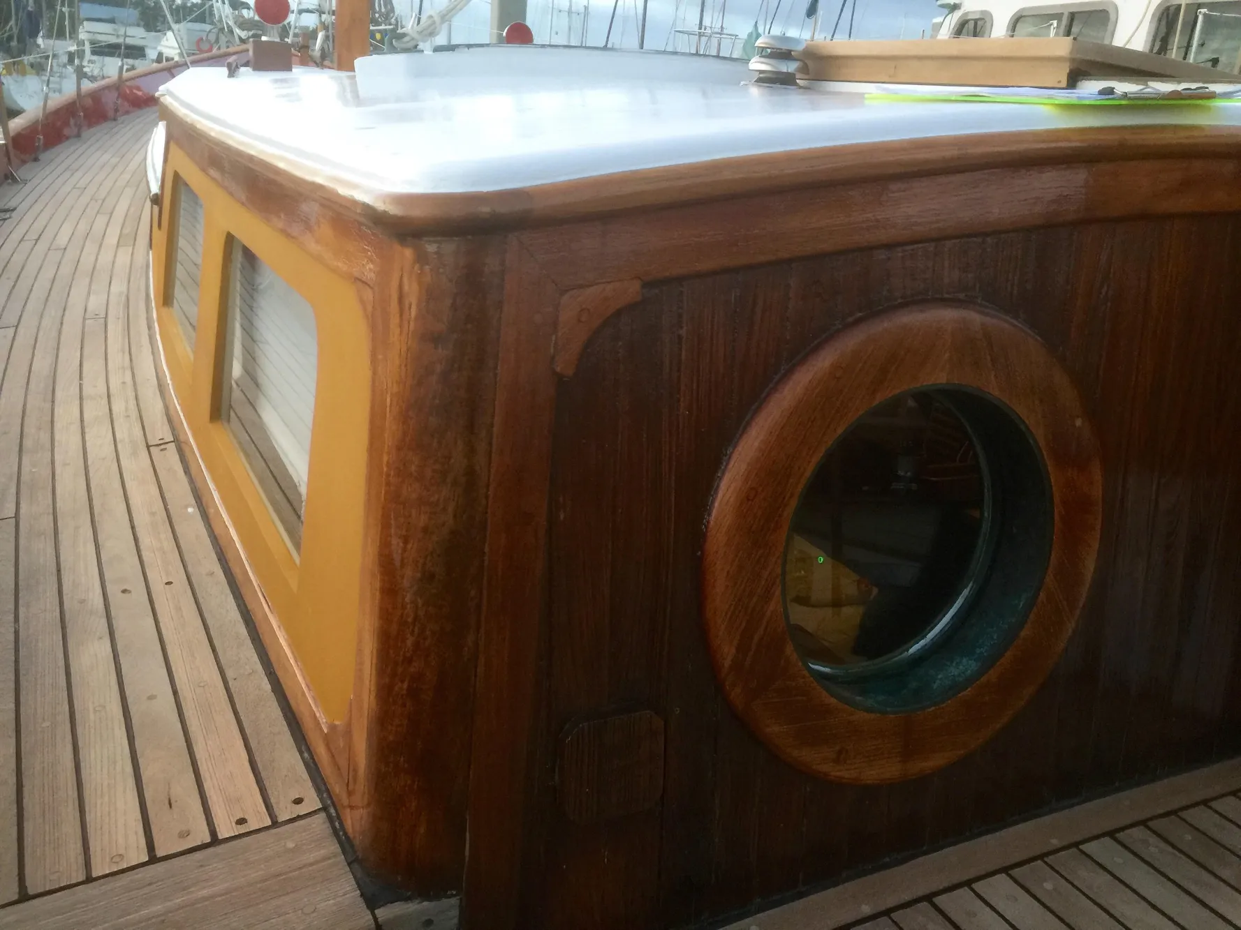 1971 Formosa 41 yacht with wooden deck and cabin, featuring a round porthole window.