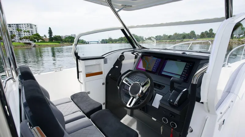 In-stock 2024 Nimbus T9 #143 Yacht Photos Pics Interior of 2024 Nimbus Tender 9 #143 boat with modern dashboard and waterfront view.