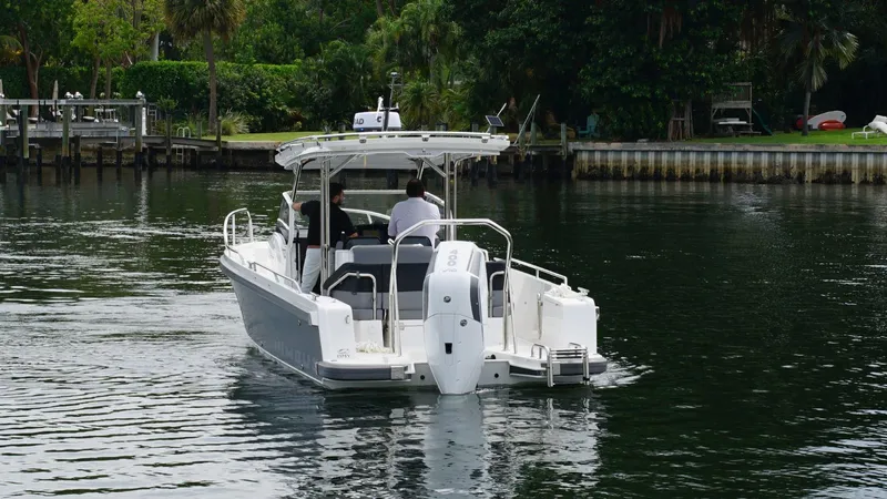 In-stock 2024 Nimbus T9 #143 Yacht Photos Pics 2024 Nimbus Tender 9 #143 motorboat cruising on a calm waterway.