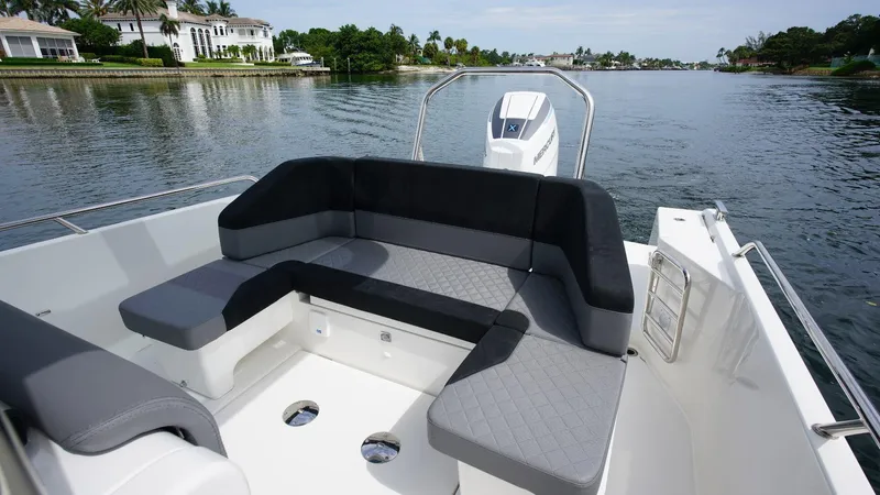 In-stock 2024 Nimbus T9 #143 Yacht Photos Pics 2024 Nimbus Tender 9 #143 boat with spacious seating on a serene waterway.