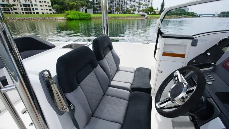 In-stock 2024 Nimbus T9 #143 Yacht Photos Pics 2024 Nimbus Tender 9 #143 interior with dual seats and steering wheel.
