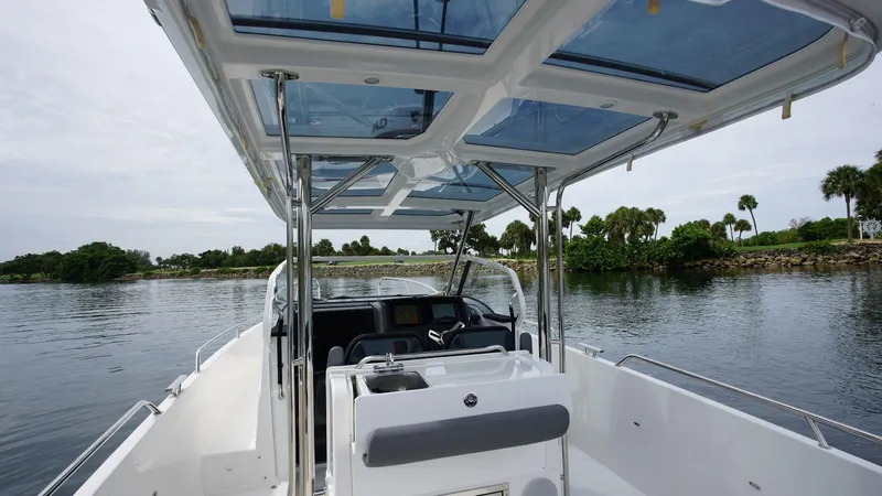 In-stock 2024 Nimbus T9 #143 Yacht Photos Pics 2024 Nimbus Tender 9 #143 boat interior with open water and lush greenery.
