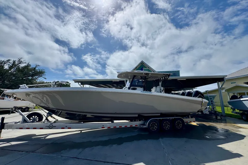  Yacht Photos Pics 2020 Fountain 38 Tournament Edition boat on trailer under blue sky.