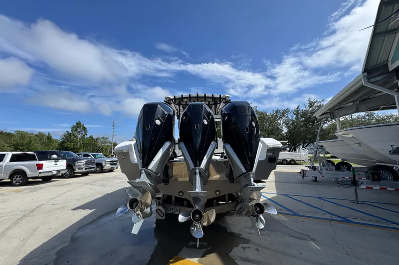  Yacht Photos Pics 2020 Fountain 38 Tournament Edition boat with triple outboard engines in a marina.